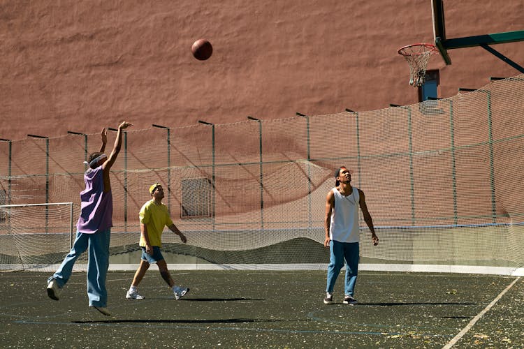 A Group Of Men Playing Basketball 