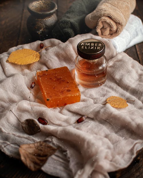 A Bar of Soap on a Towel and Autumn Leaves 