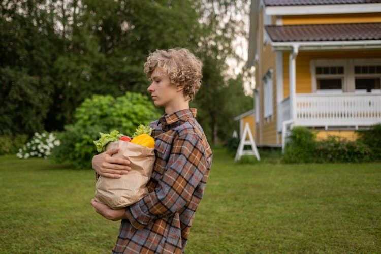 Teenage Boy Holding Groceries