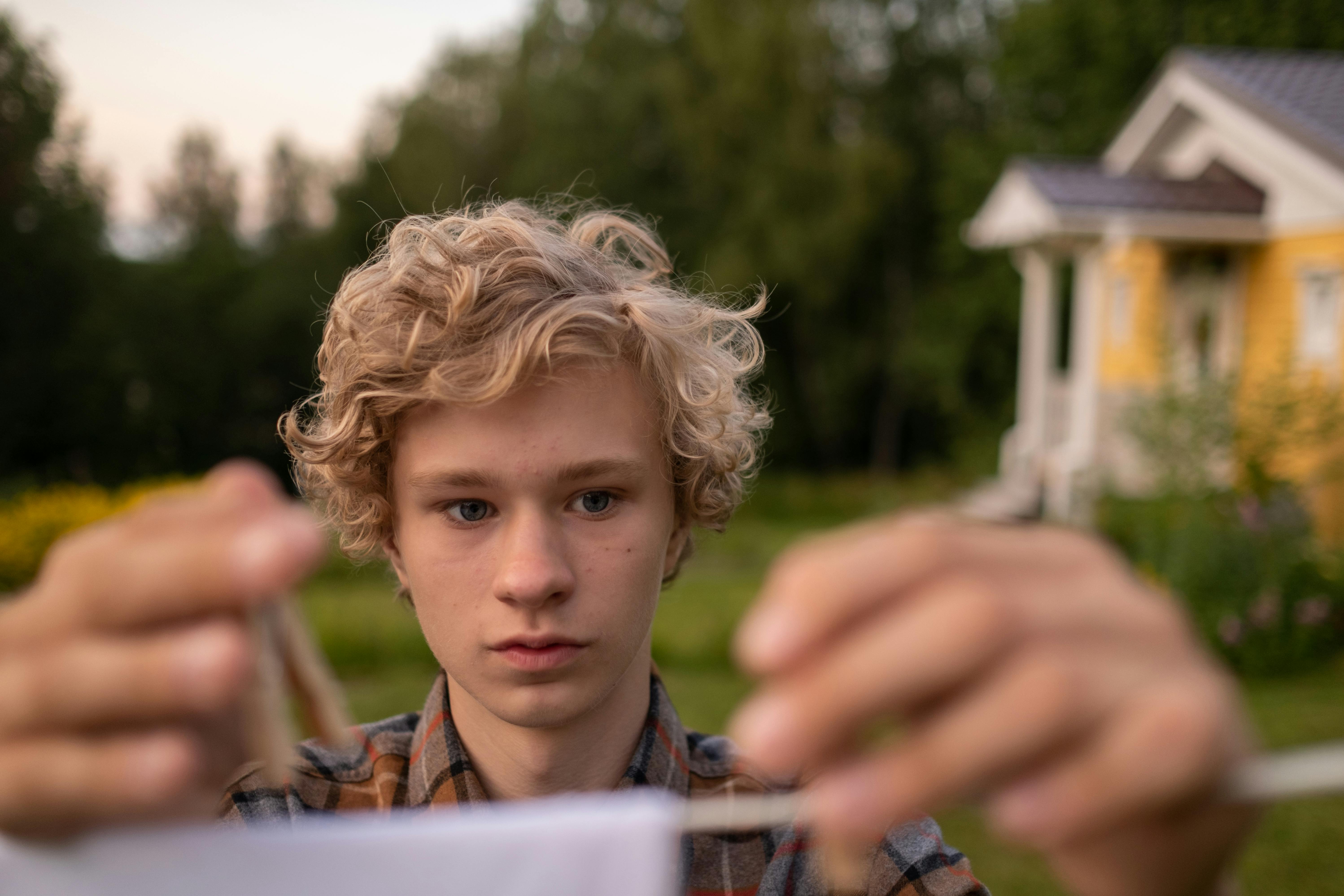 teenage boy hanging clothes