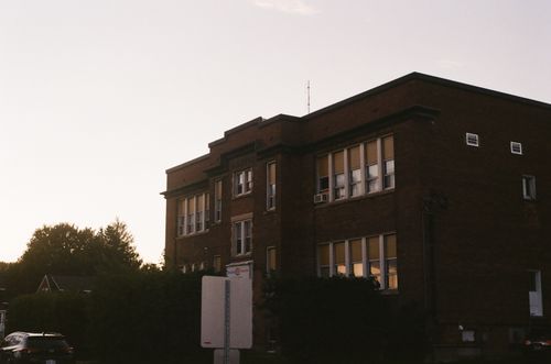 Free An old brick building with large windows captured during sunset. Stock Photo