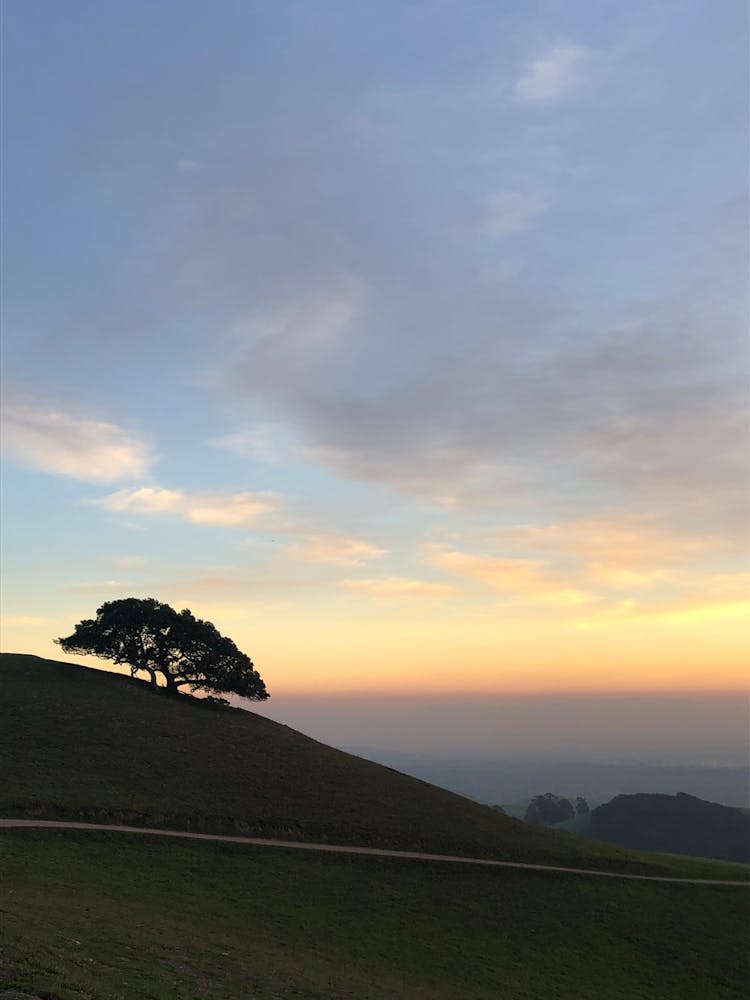 Idyllic Landscape Of A Sunset Over A Hill 