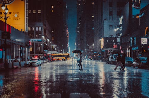 A Person Crossing the Road on a Rainy Day