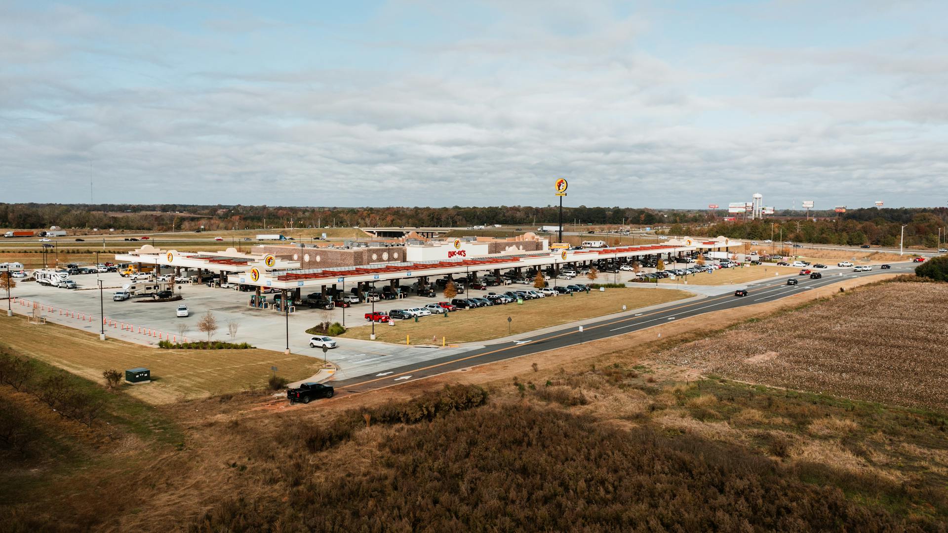 Wide aerial view of Buc-ee's gas station in Warner Robins, Georgia surrounded by lush landscape.