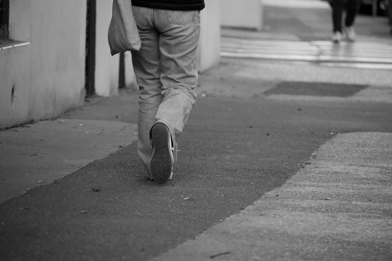 person walking a short neighborhood loop with a lanyard still on