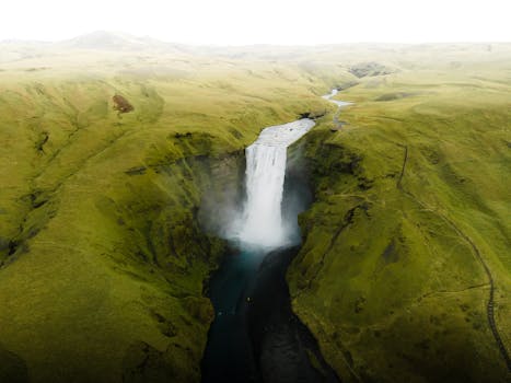Explore the majestic Skógafoss Waterfall, a natural wonder in Iceland, captured from an aerial perspective.