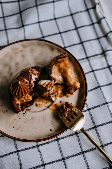 Close-up of a mouthwatering caramel brownie dessert served on a plate with a fork.