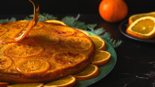 A beautifully decorated orange cake with candied orange slices, perfect for dessert lovers.