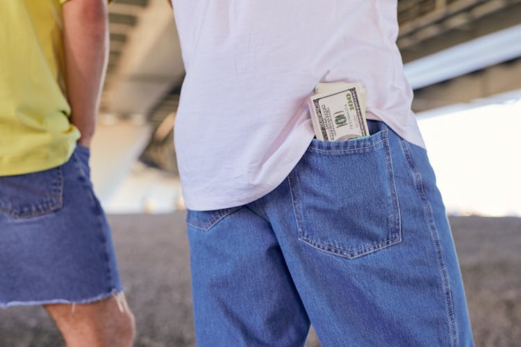 Stack Of Hundred Dollar Bills In The Back Pocket Of His Jeans