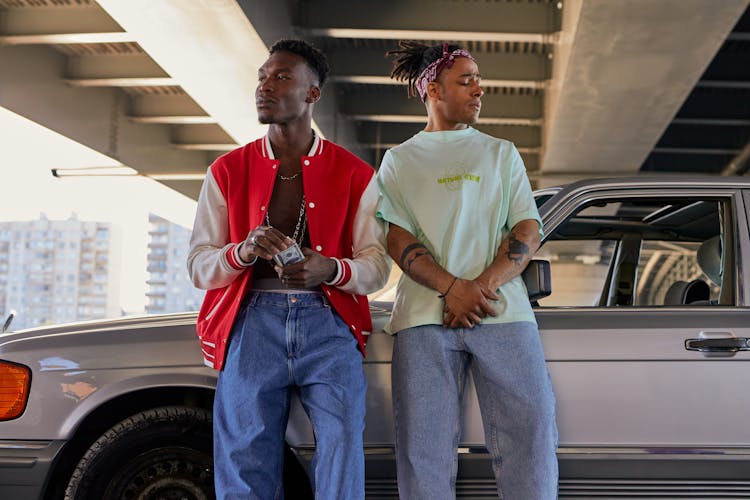 Men Leaning On The Car