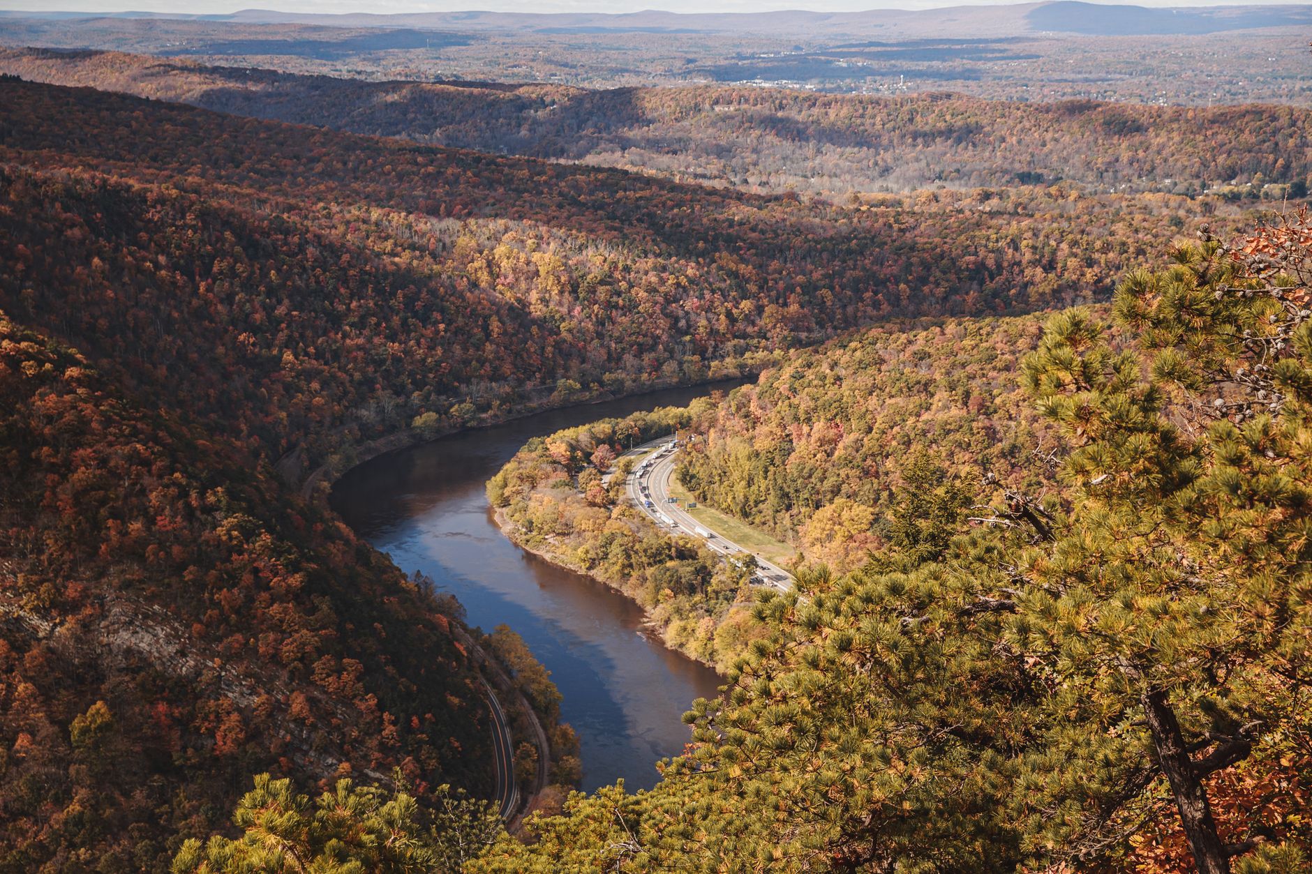 Explore the sweeping autumn landscapes at Delaware Water Gap with vibrant fall foliage and a winding river.