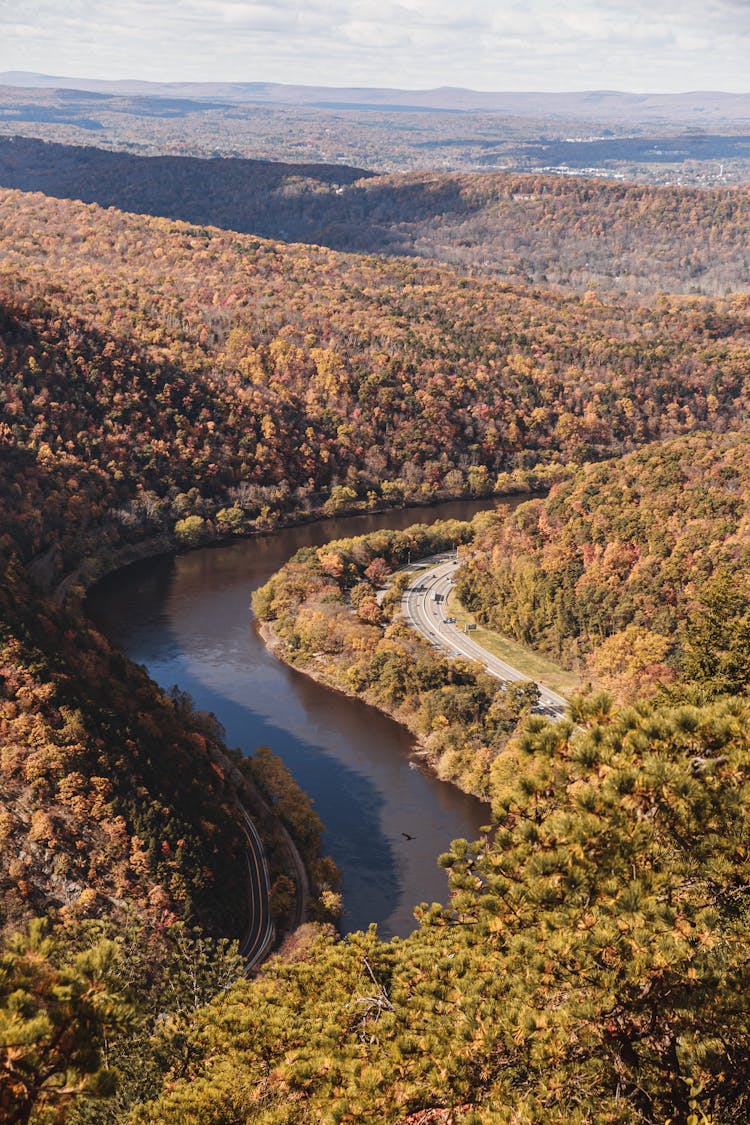 An Aerial View Of A River Between Mountains