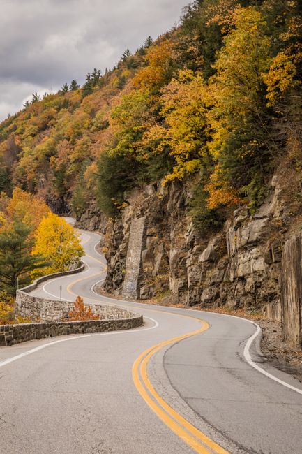 Winding road through colorful autumn foliage in Sparrow Bush, New York.
