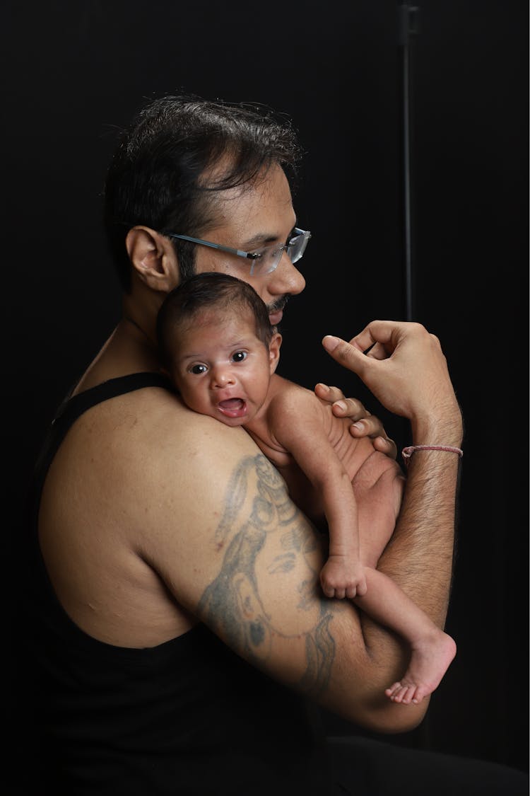 Man Holding A Newborn Baby