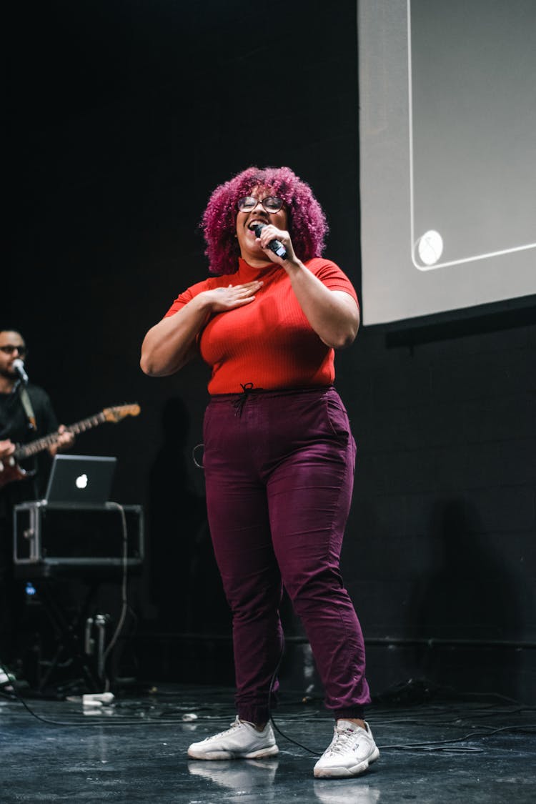 Woman With Microphone Singing On Stage