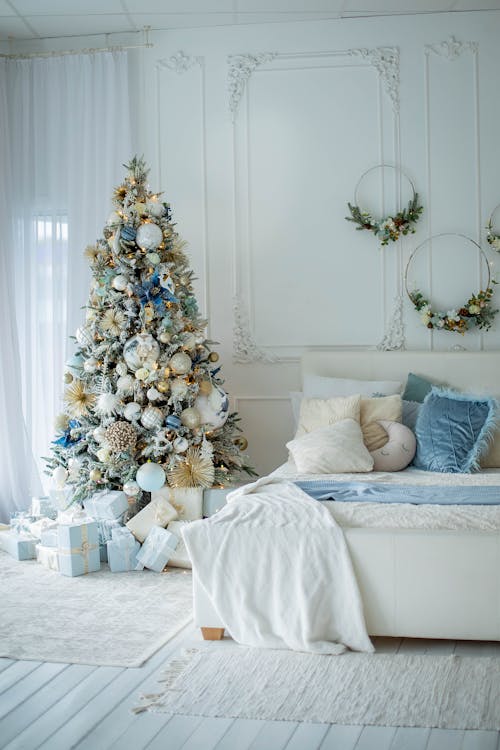 Christmas Tree and Wall Decorations in Bedroom Arranged in White and Blue 