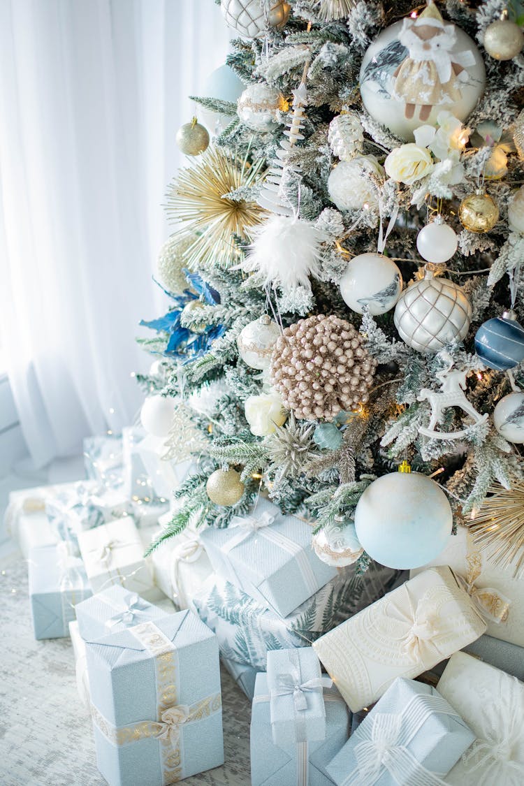 Decorated Christmas Tree And Gifts Arranged In Blue And White