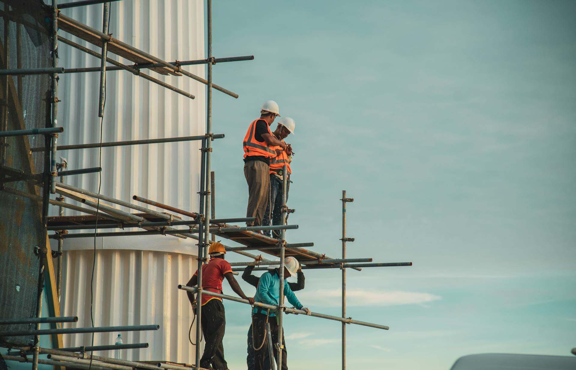 Workers assemble on scaffolding during a construction project outdoors in Maldives.