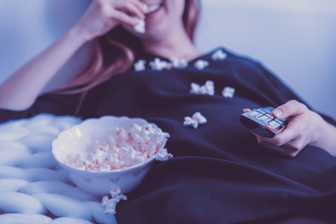 Woman Wearing Black Dress Shirt Eating Popcorn