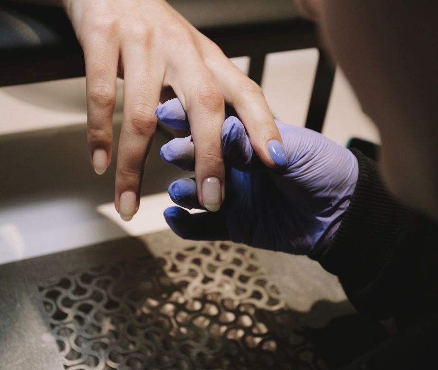 Gel polish being applied during a manicure at Nail Studio