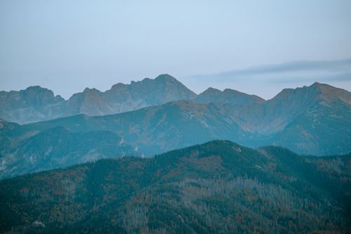 Free Breathtaking view of a mountain range shrouded in mist during early morning hours. Stock Photo