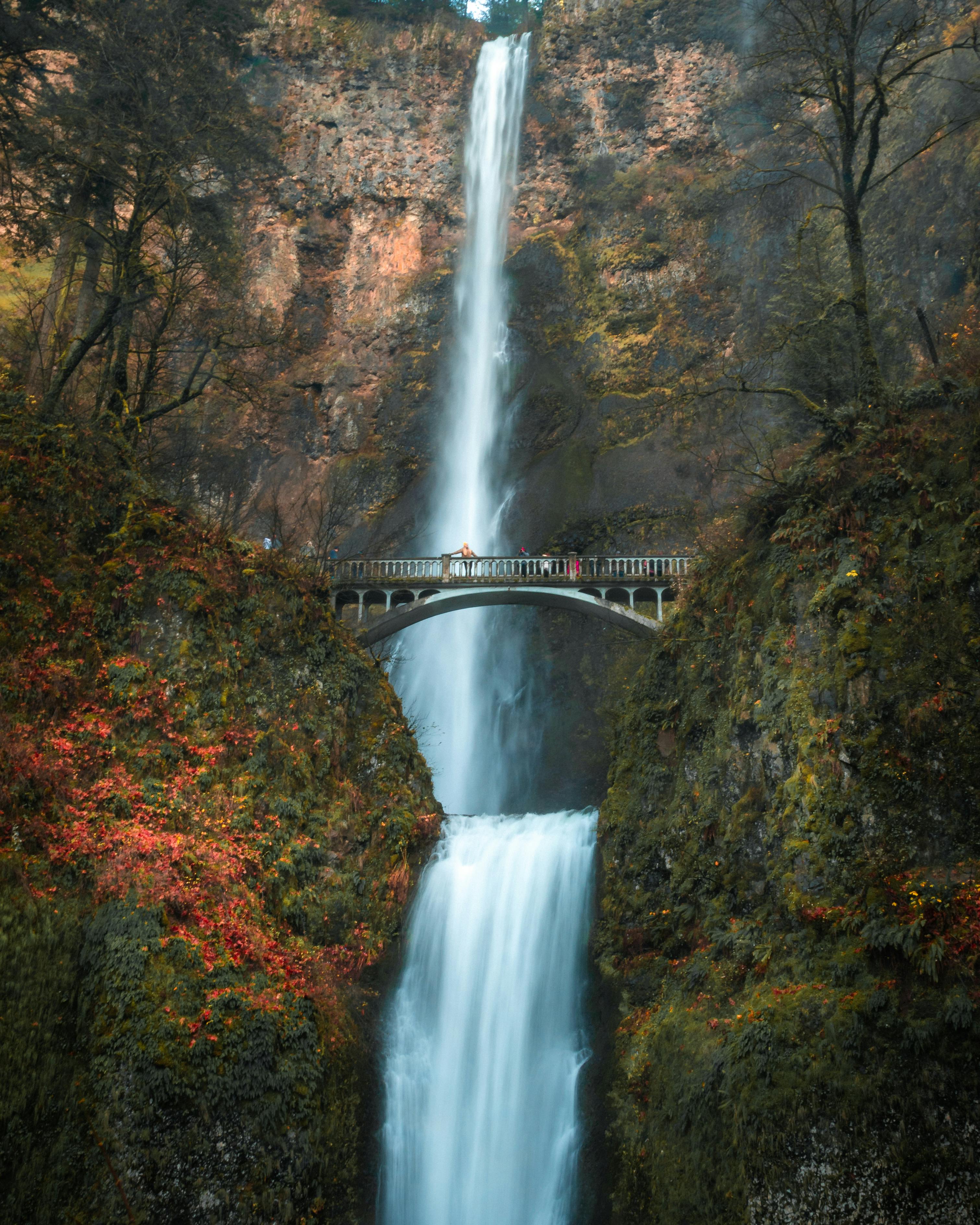 Breathtaking rapid waterfall streaming through rocky cliff in gorge ...