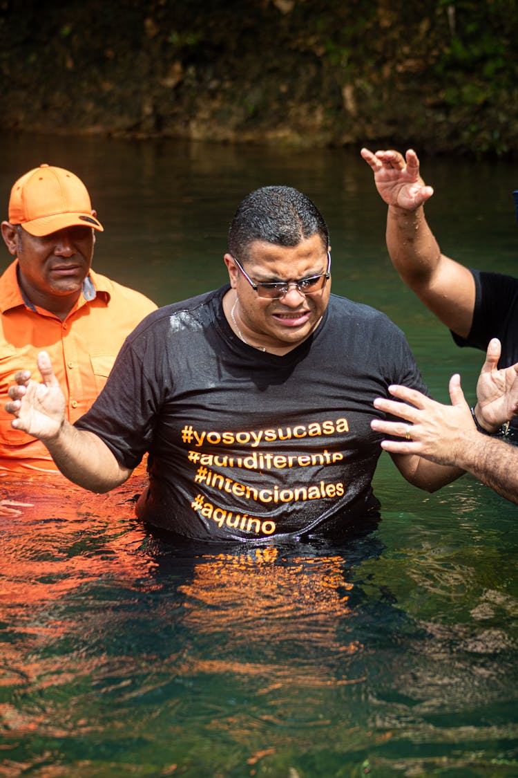 Man Standing Waist Deep In Water During A Baptism