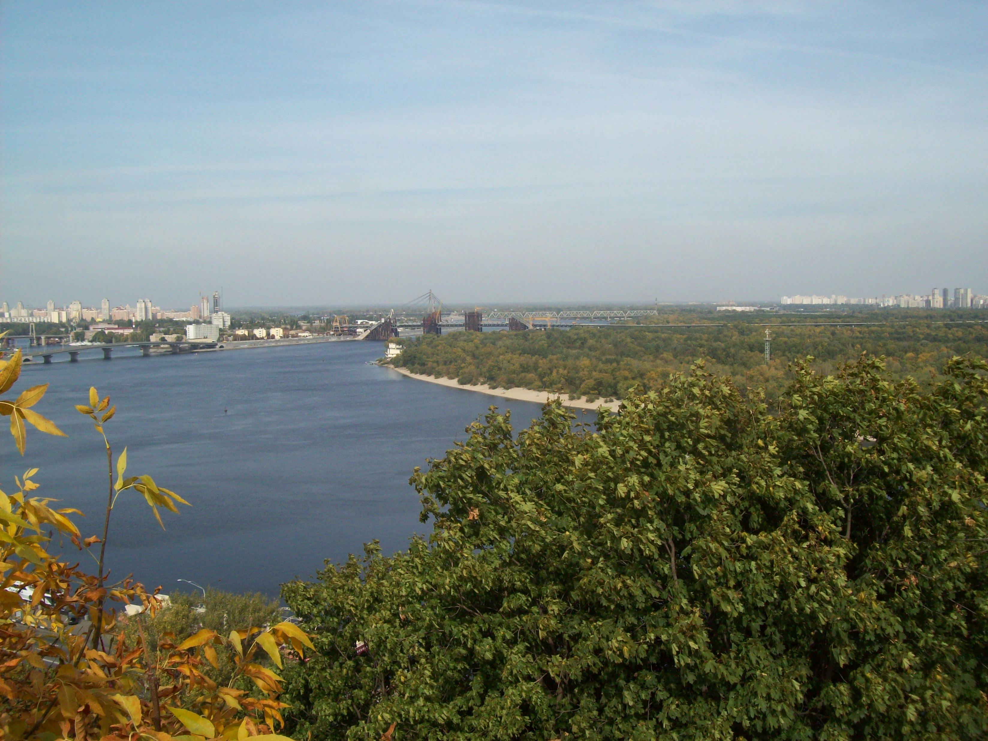 Close-up of woman's arched back with feather trailing sensually over skin in dim light