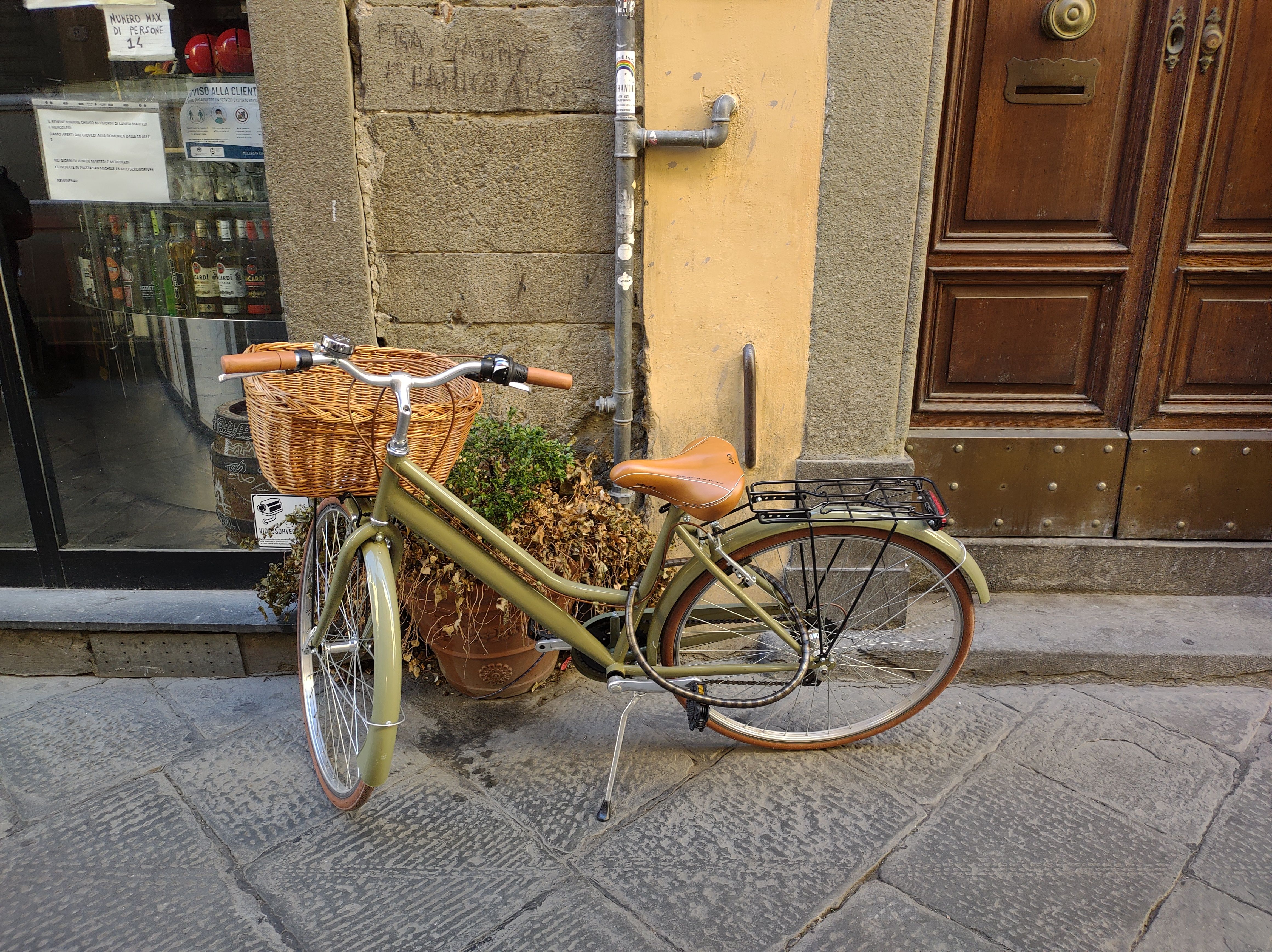 Vintage bicycle with basket on a picturesque street in Lucca, Tuscany, Italy.
