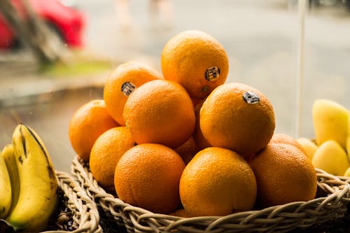 Free Close Up Photo of Oranges on Woven Basket Stock Photo