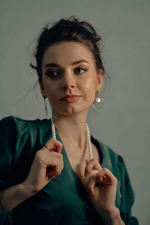 A Woman Wearing Pearl Earrings