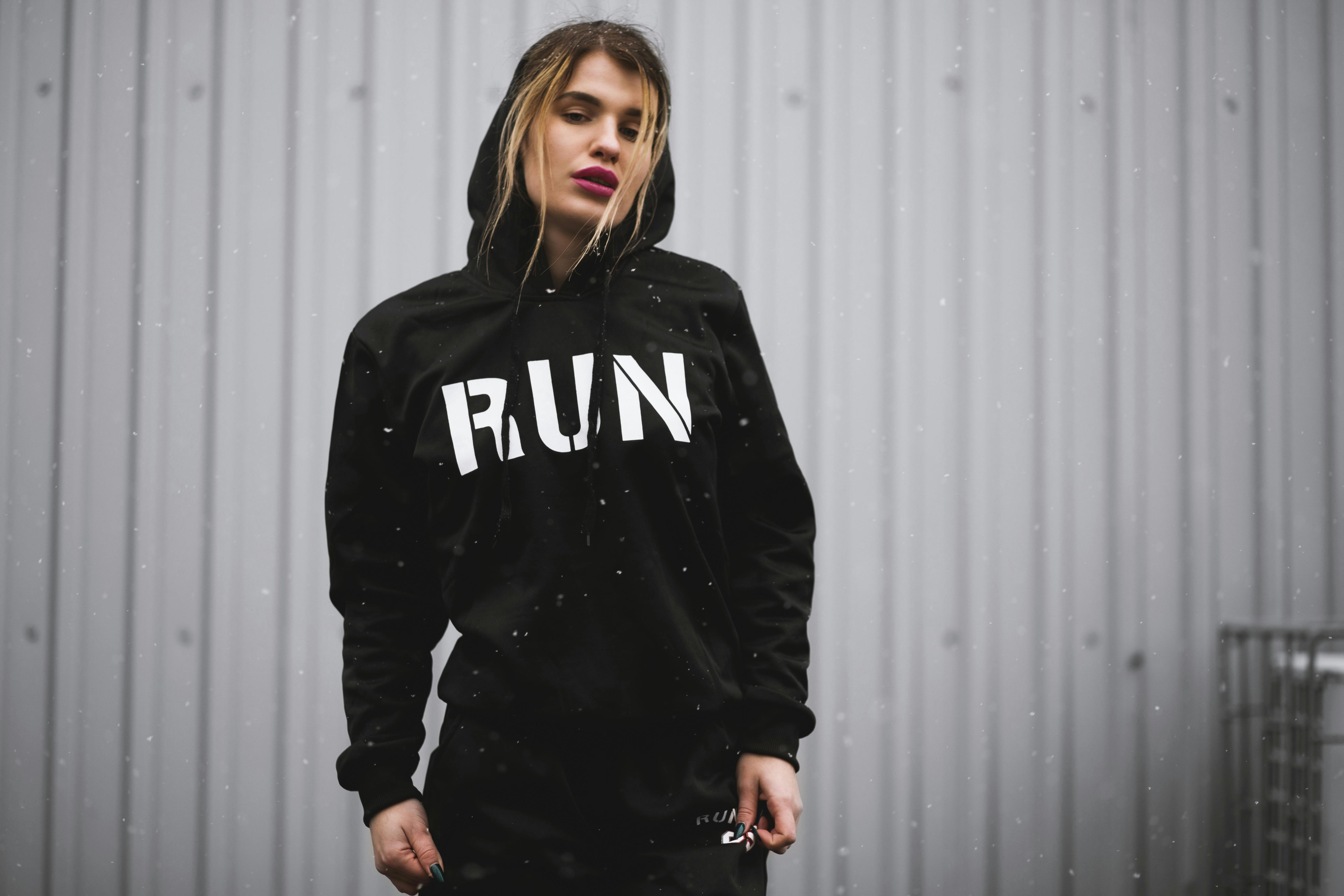 woman wearing black and white run printed pullover hoodie