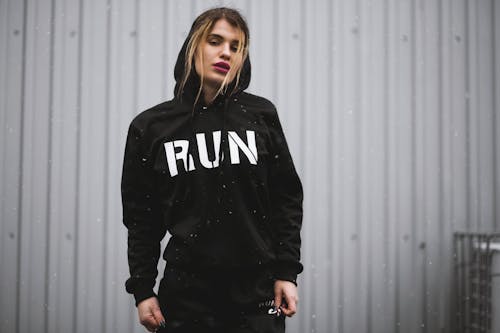 Woman Wearing Black and White Run-printed Pullover Hoodie