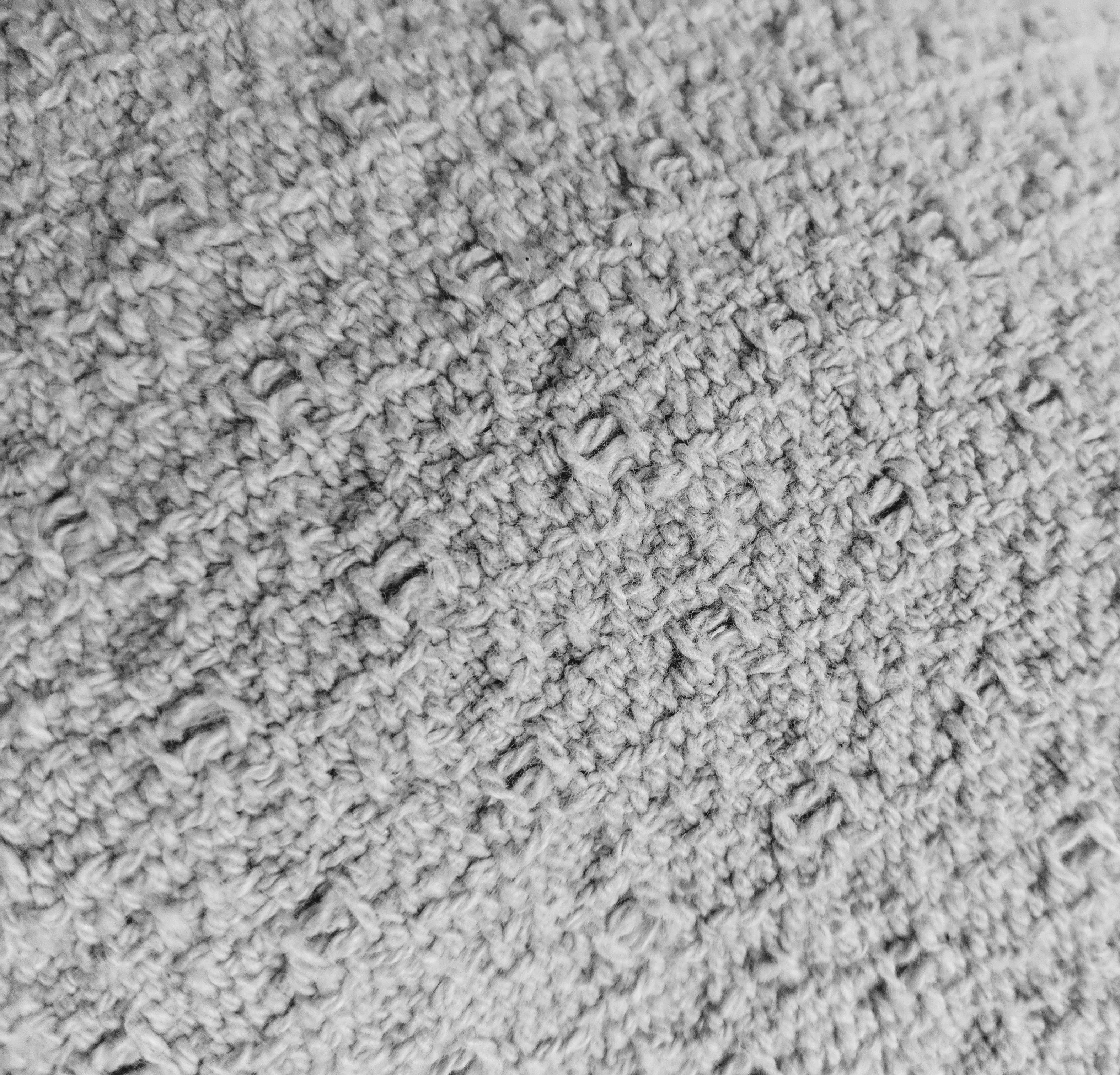 Young football fan wearing a jersey and holding a ball in a stadium