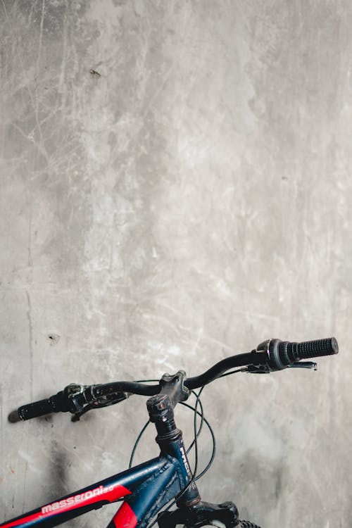 Bicycle Parked Beside a Concrete Wall