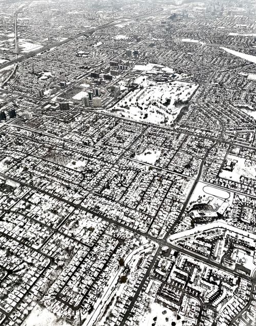 Free Aerial view of a city covered in snow, showcasing urban planning and winter scenery. Stock Photo