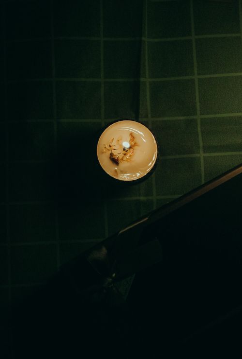 Free Top view of a candle burning in dim light, creating a warm and cozy atmosphere. Stock Photo