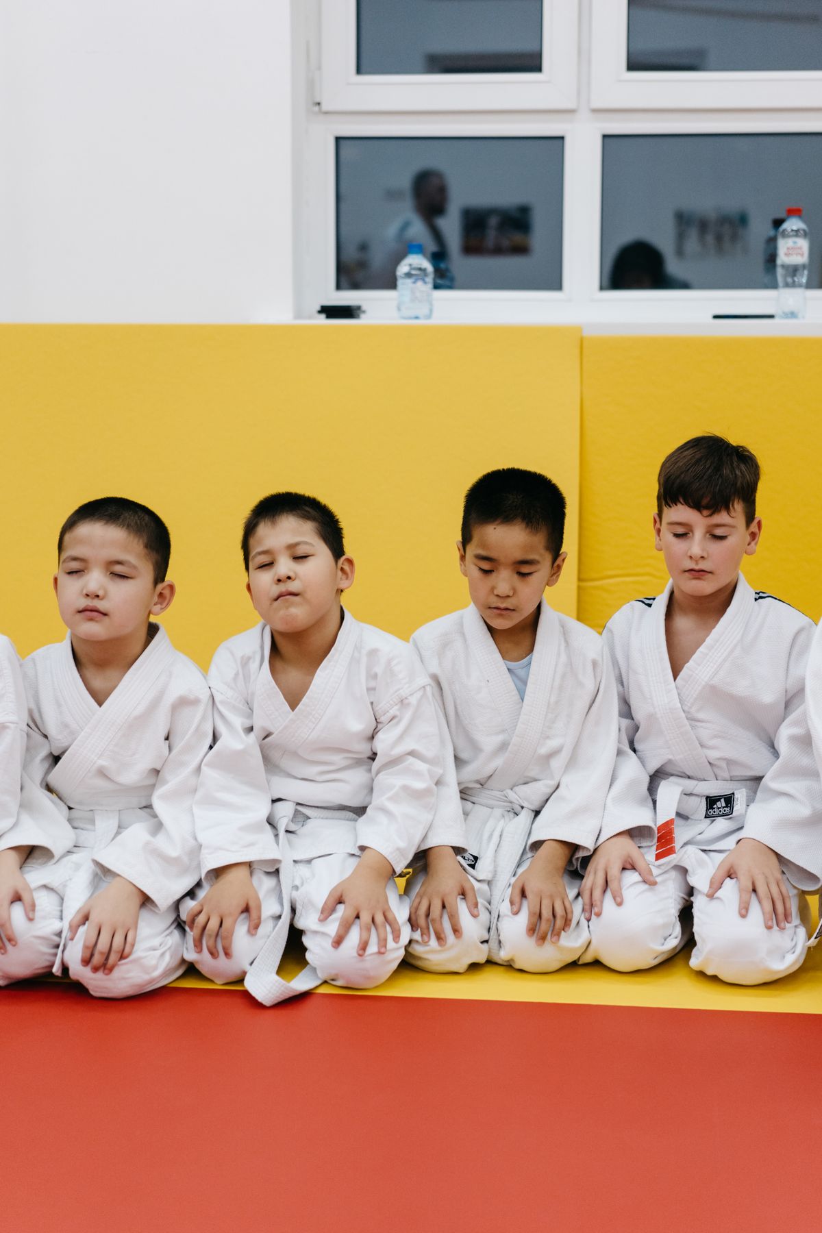 Young students stretching together at the dojo