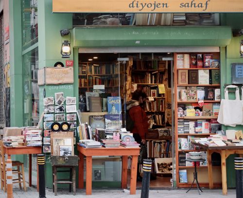 Free Explore a bustling vintage bookstore with an inviting display of eclectic books and unique gifts. Stock Photo