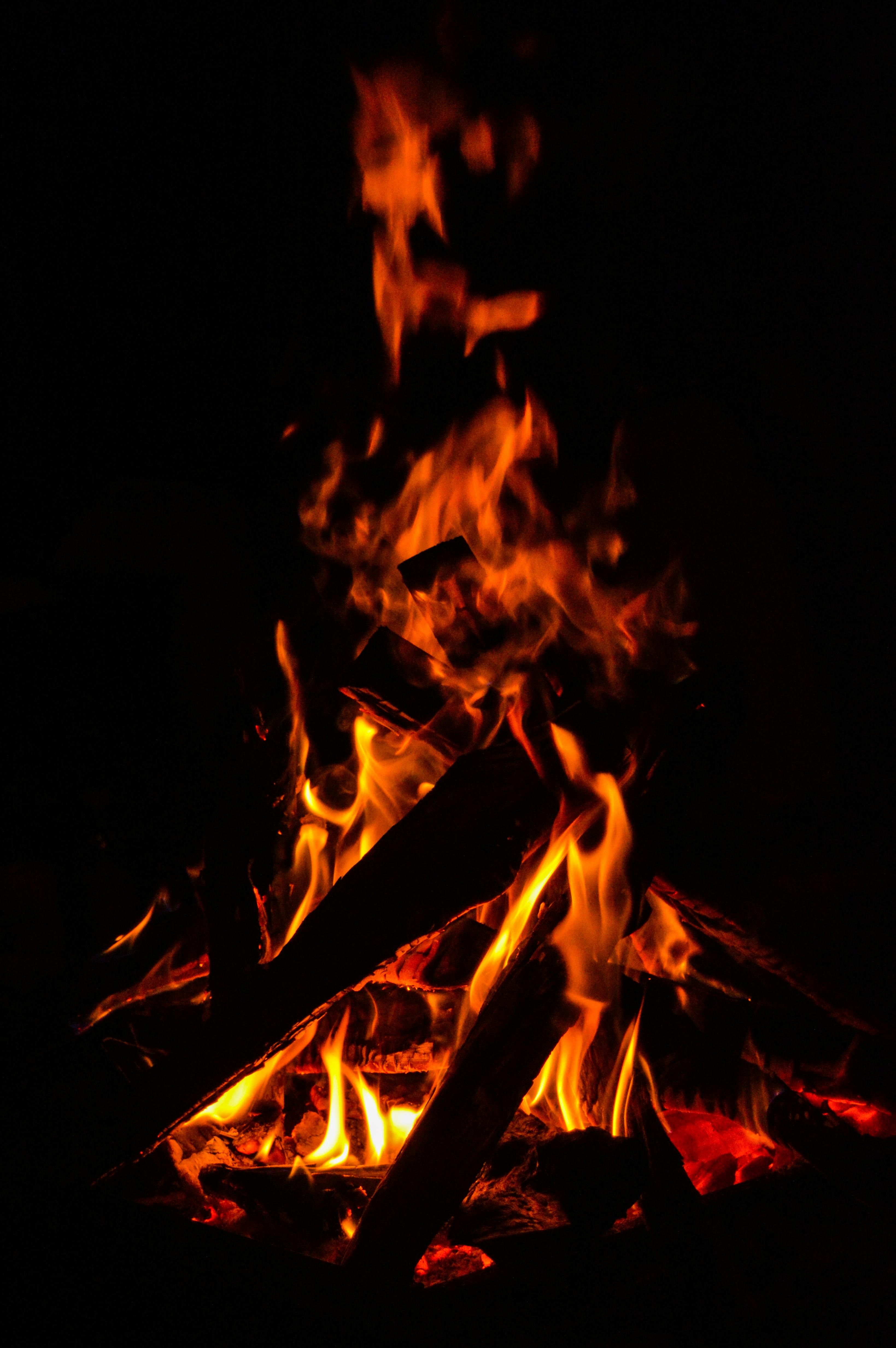 Photo of Bonfire Placed on High Ground in Front of City Under Cloudy ...