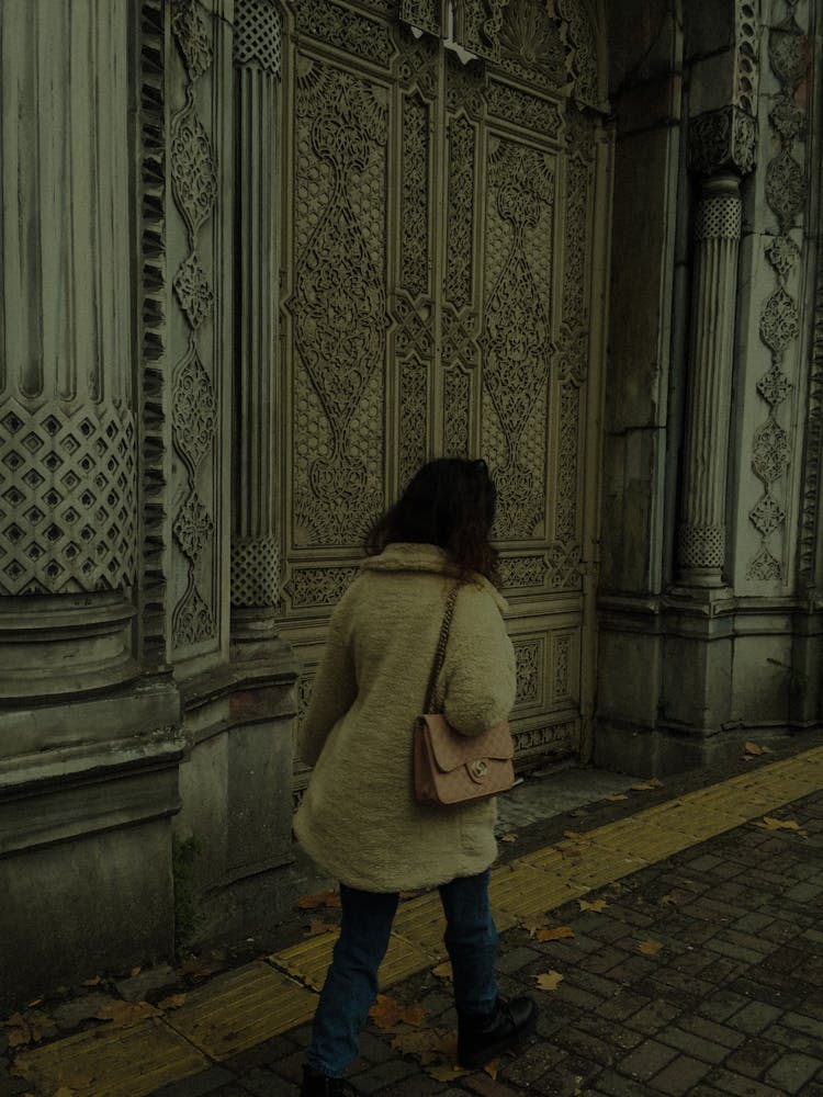 Woman Walking Near Old Historic Building