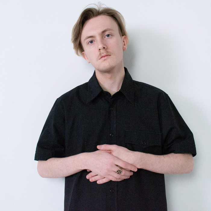 A person wearing a plain black tee — photo by Анатолий К. on Pexels