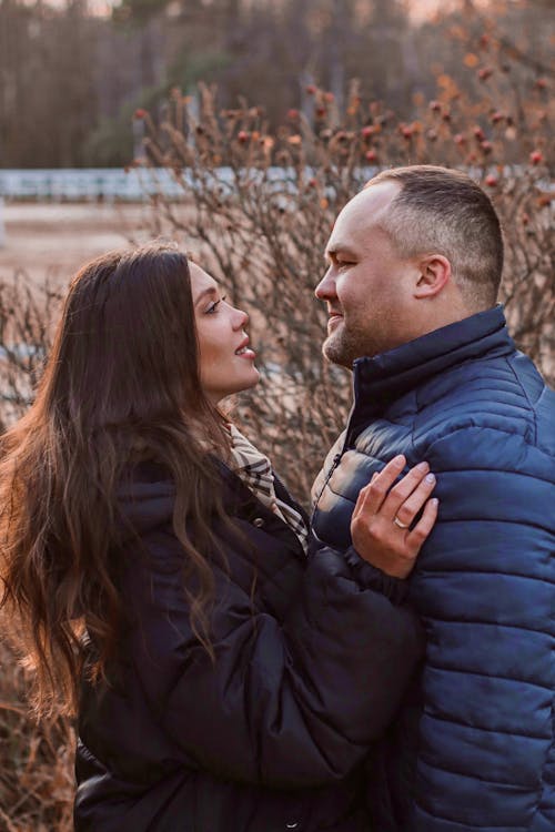 Free Man in Blue Bubble Jacket Looking at a Woman in Black Jacket Face to Face Stock Photo