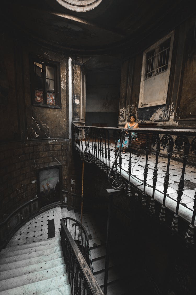 Woman Sitting On Bench In Old Historic Building