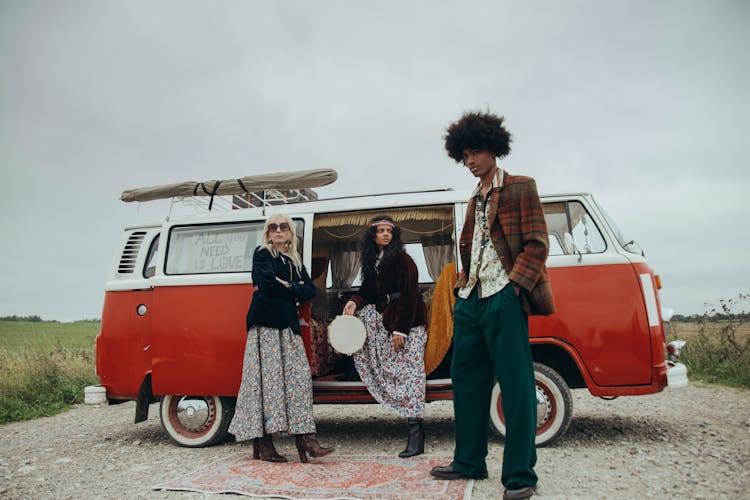 Man And Women Standing Beside A Van