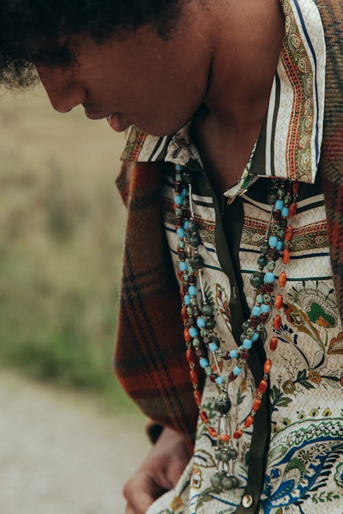 Man in Printed Shirt Wearing Necklaces with Beads