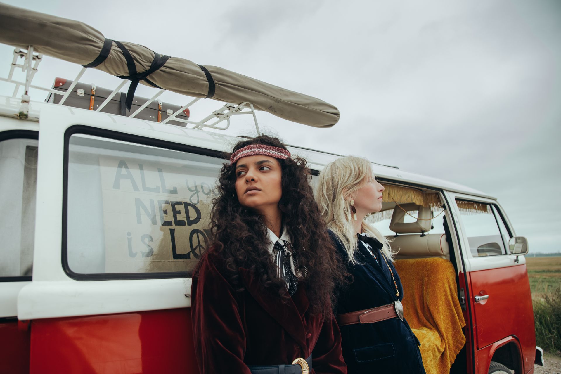 Women Standing Side by Side Beside a Van