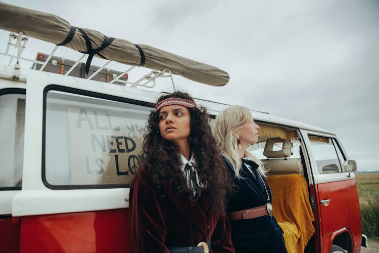 Women Standing Side By Side Beside A Van