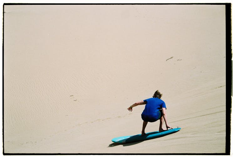 Man Surfing On Sand