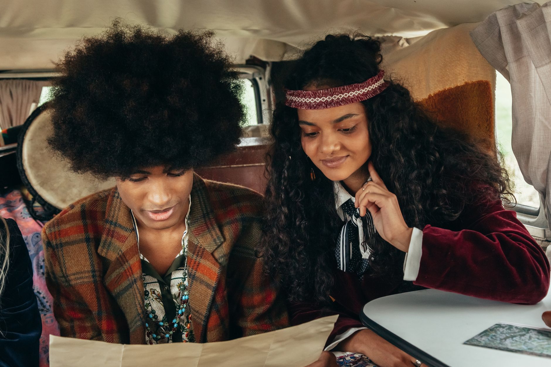 Young couple with retro style enjoying a moment inside a vintage van. Perfect for lifestyle imagery.